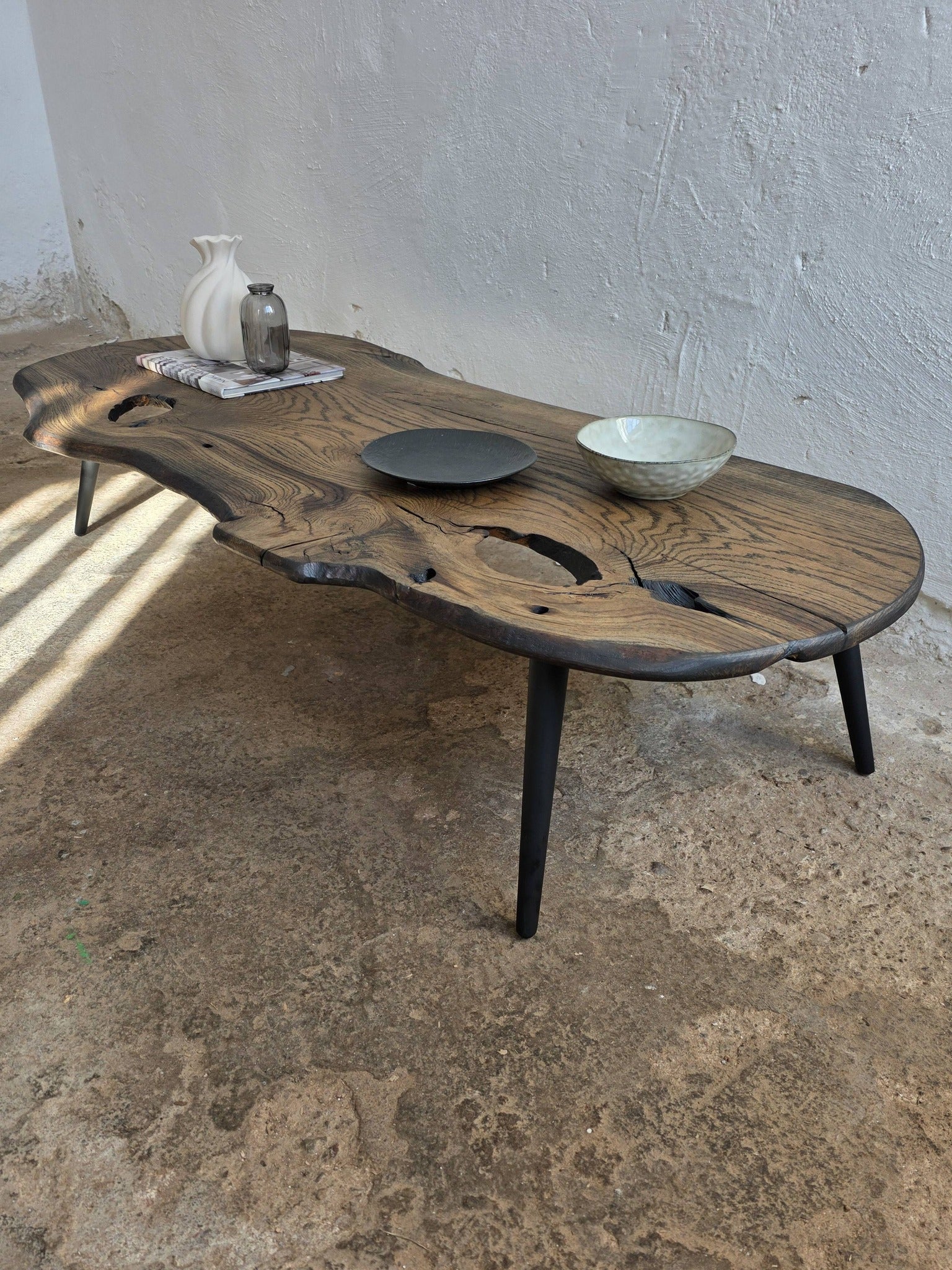 Wooden coffee table with rustic design on a concrete floor