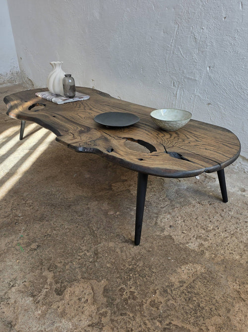 Wooden coffee table with rustic design on a concrete floor